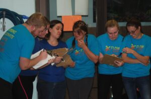 swim-coaches-grading-score-cards-while-being-goofy-at-flow-aquatics-swim